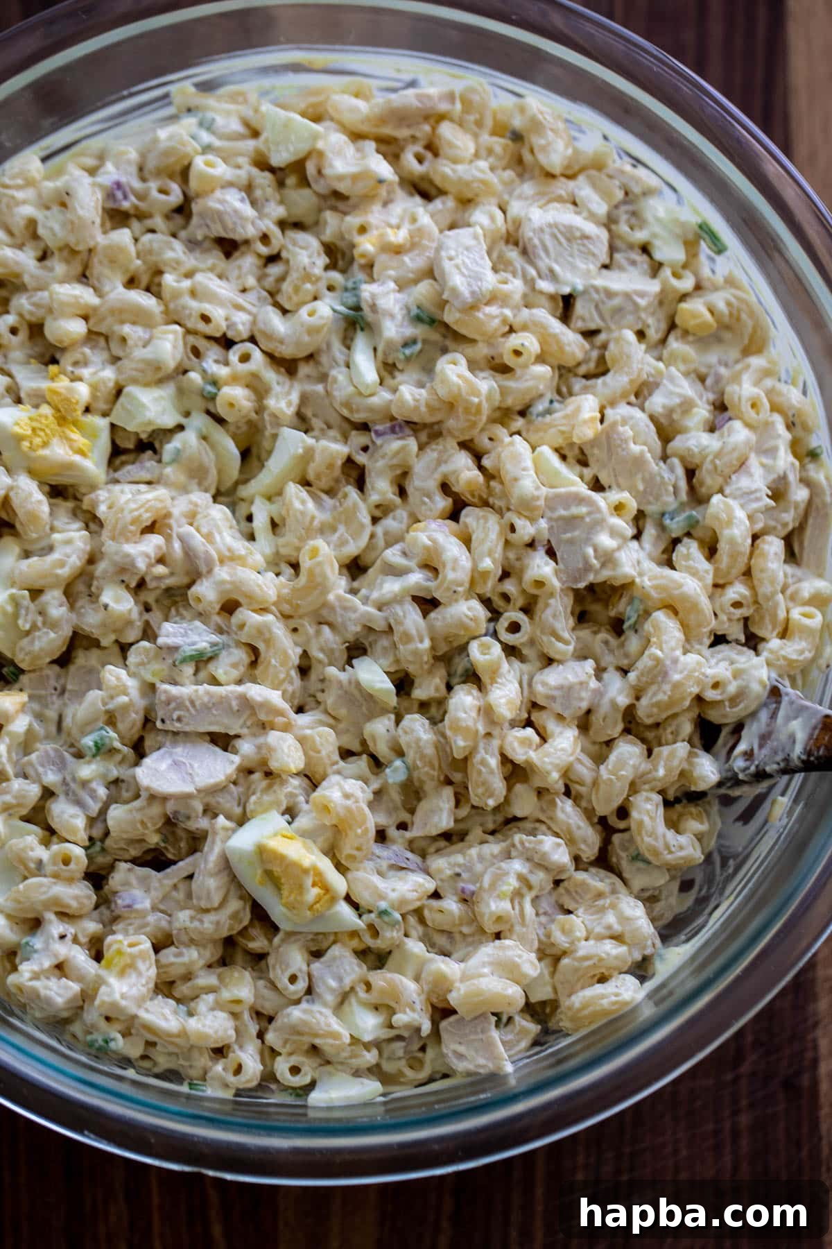 Creamy Chicken Macaroni Delight 8 The fully mixed, creamy chicken macaroni salad in a large bowl, ready for chilling.