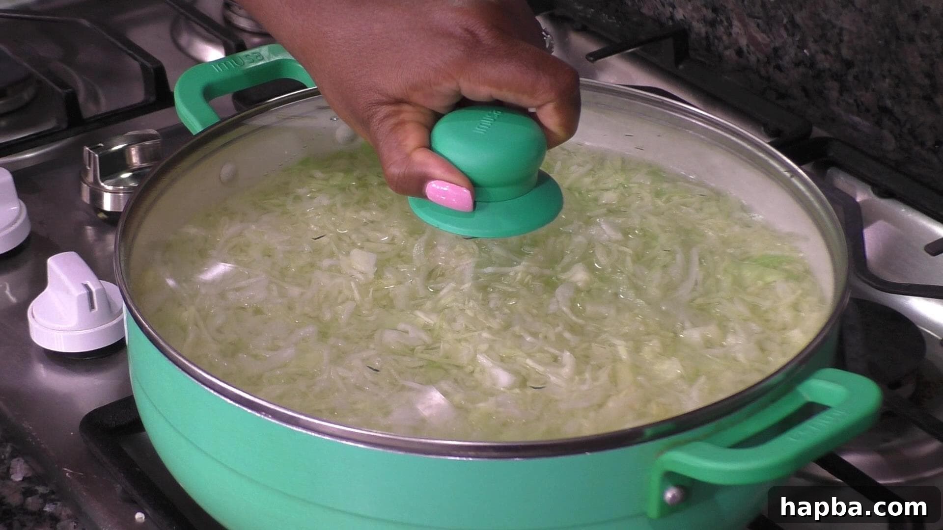Shredded cabbage gently blanched in a pot of hot water, ready for the next step.