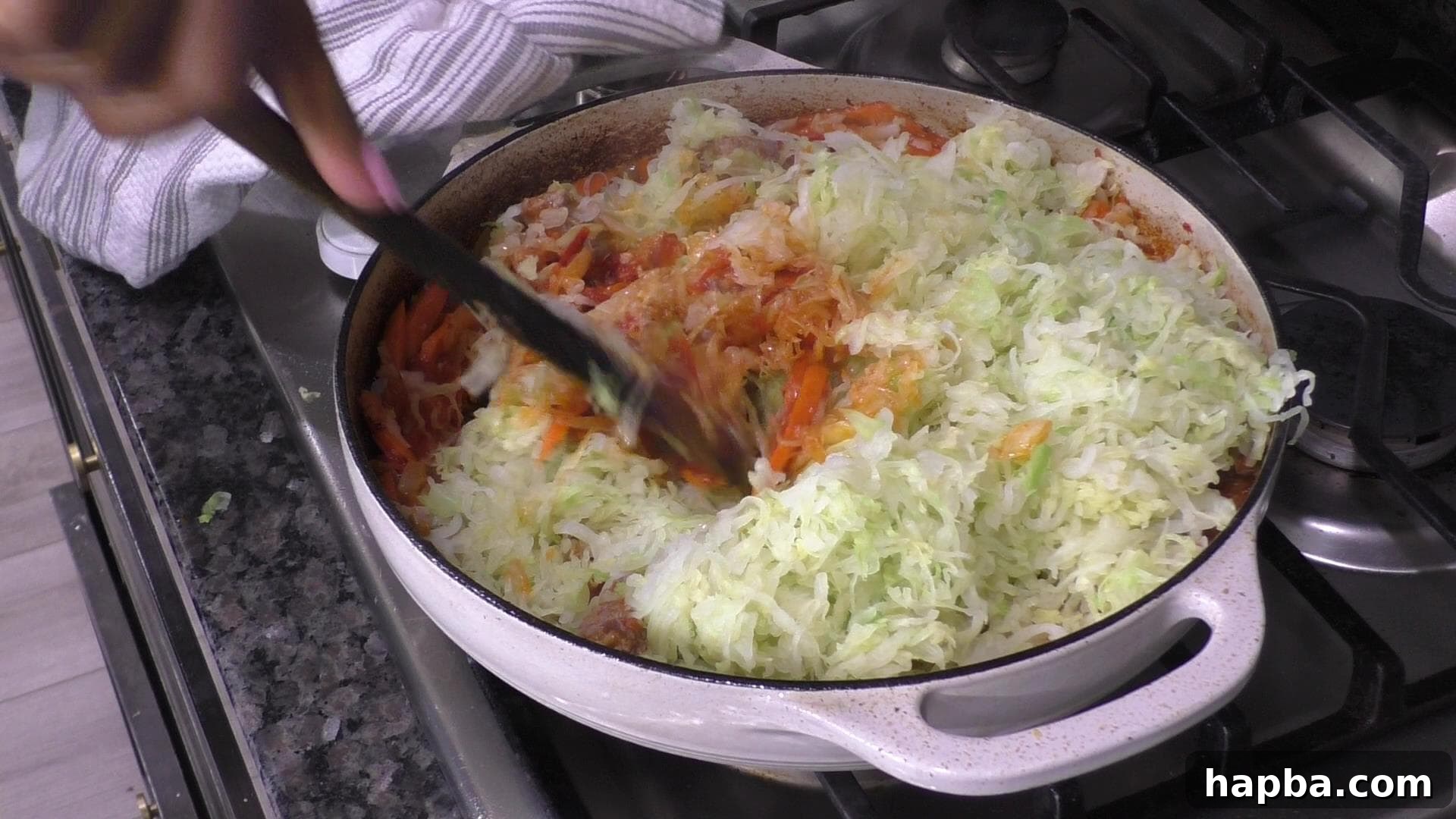 The prepped cabbage added to the pot with other ingredients, ready to be stirred and simmered.
