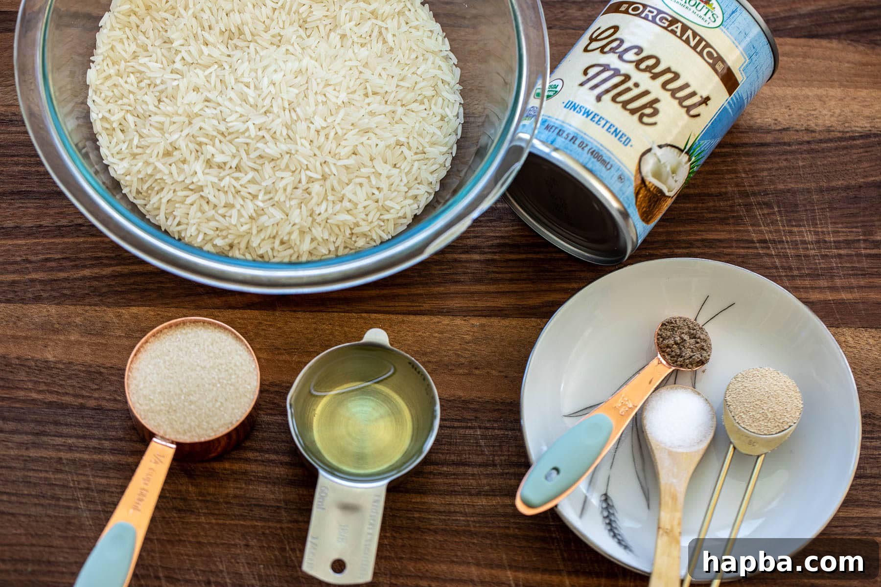 Fluffy East African Coconut Rice Pancakes 3 Ingredients for Vitumbua coconut rice pancakes laid out on a wooden chopping board.
