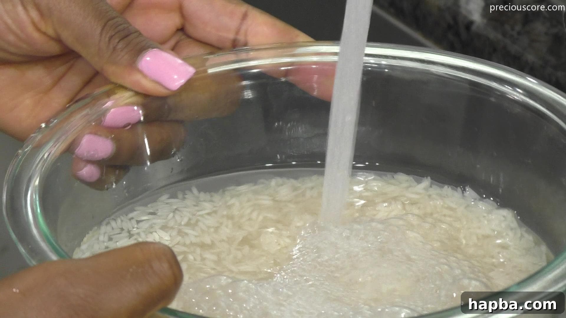 Fluffy East African Coconut Rice Pancakes 4 Water being poured over rice in a bowl for soaking overnight.