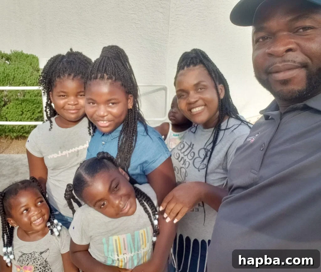 Smiling Black family gathered together with a beautiful backdrop, enjoying their Lake Havasu vacation.