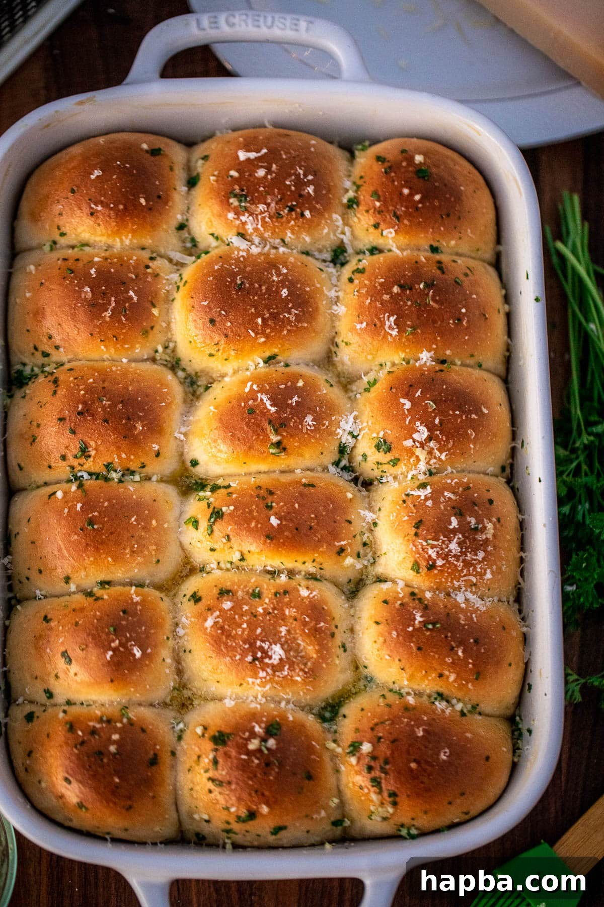 Garlic Butter rolls with grated parmesan cheese sprinkled on top, still warm in the baking dish.