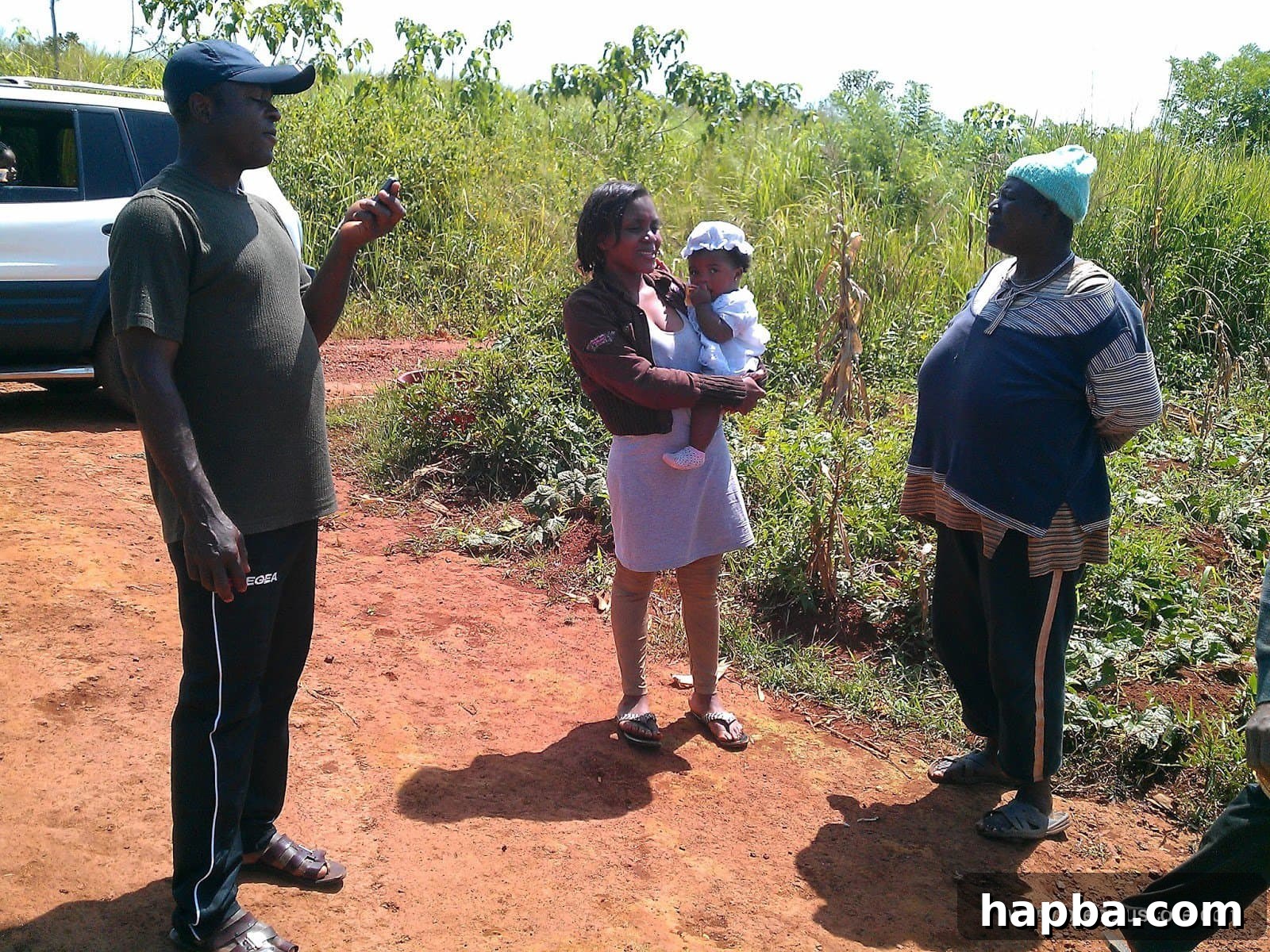 Author with child in a natural, rural setting in a Cameroonian village