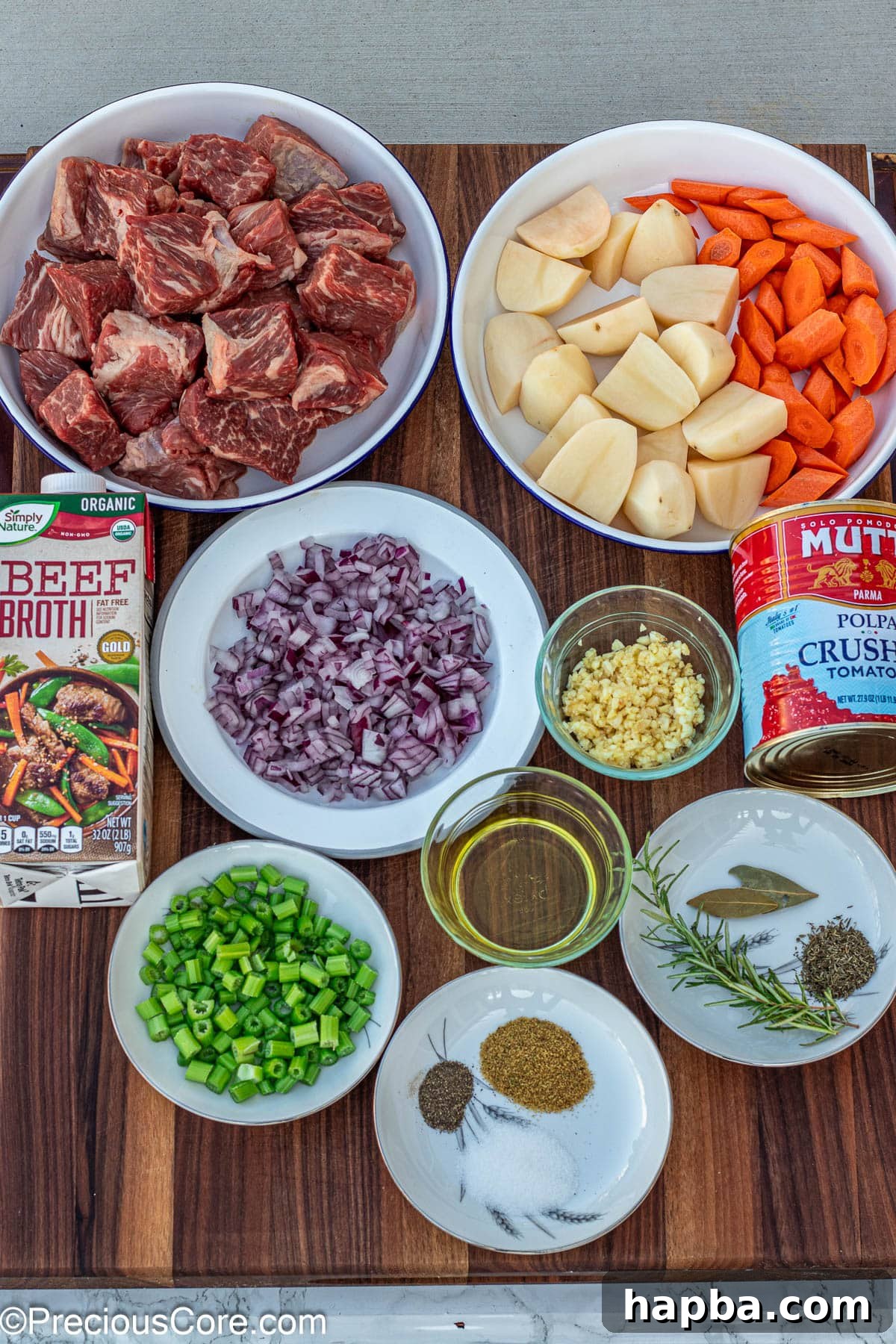 Non-Alcoholic Beef Stew 5 Fresh ingredients laid out for making beef stew without wine or flour, highlighting their quality.