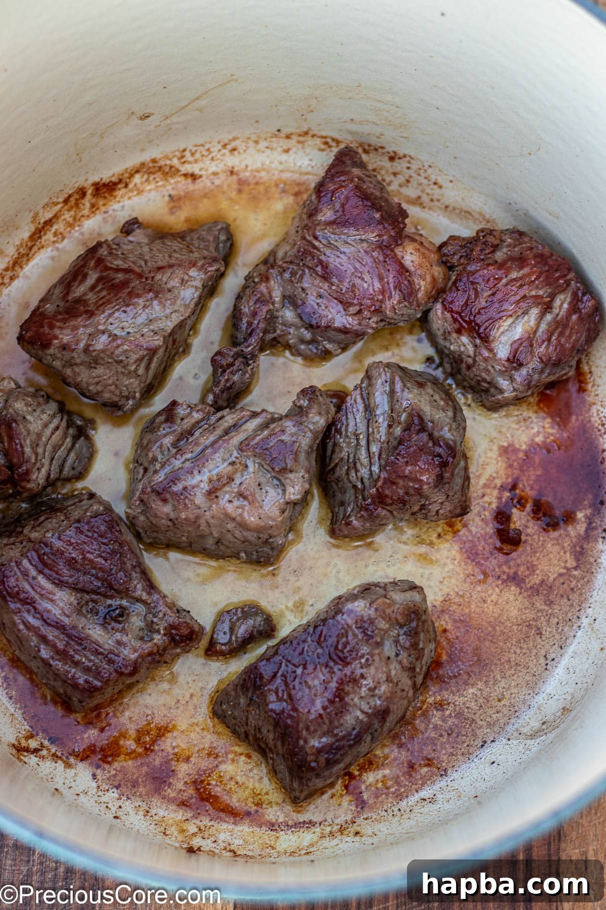 Non-Alcoholic Beef Stew 7 Chuck roast beef browning in a hot Dutch oven, creating a delicious crust.