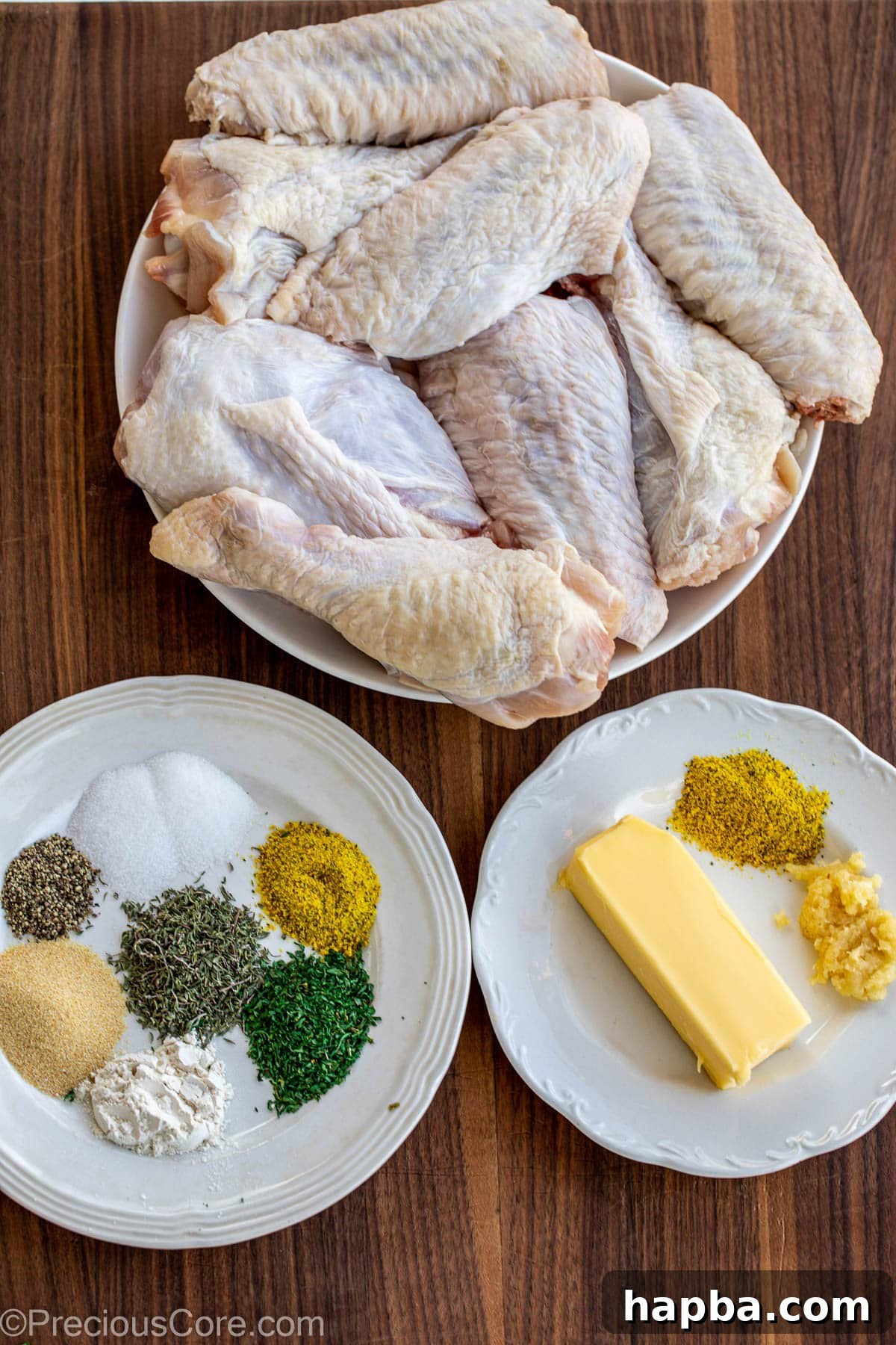 Turkey Wings, seasoning and butter on a chopping board.