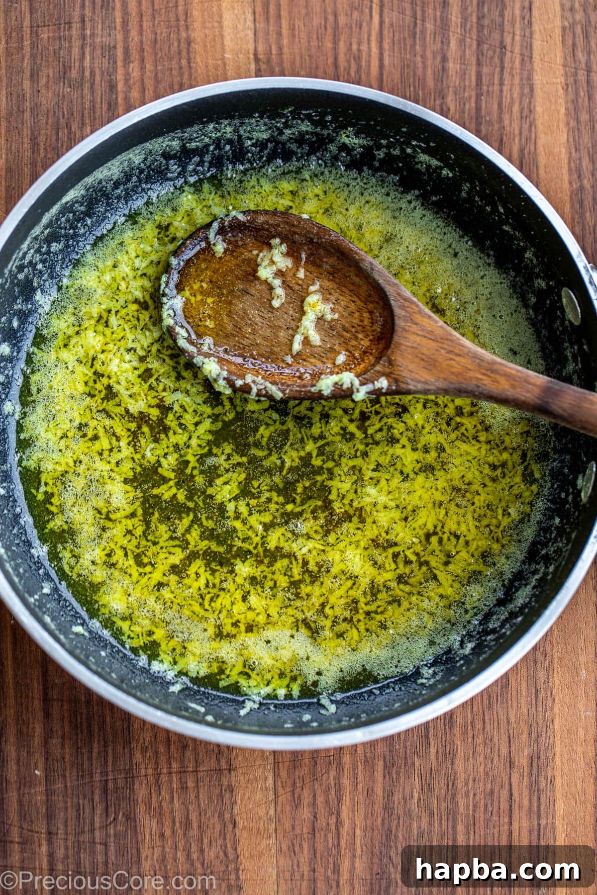 Butter sauce with lemon pepper seasoning in a skillet.
