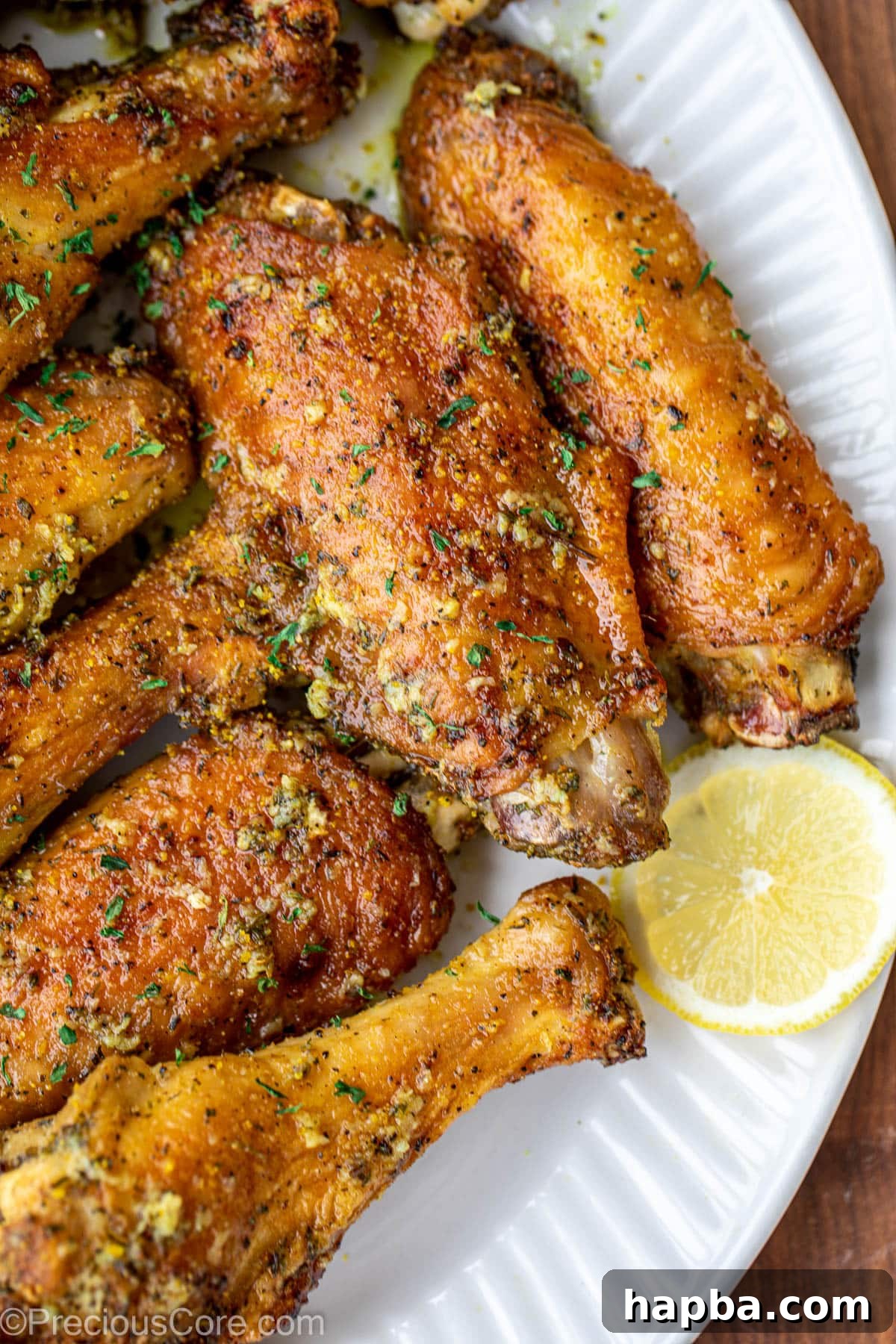 Wings on a serving platter, garnished with a slice of lemon.