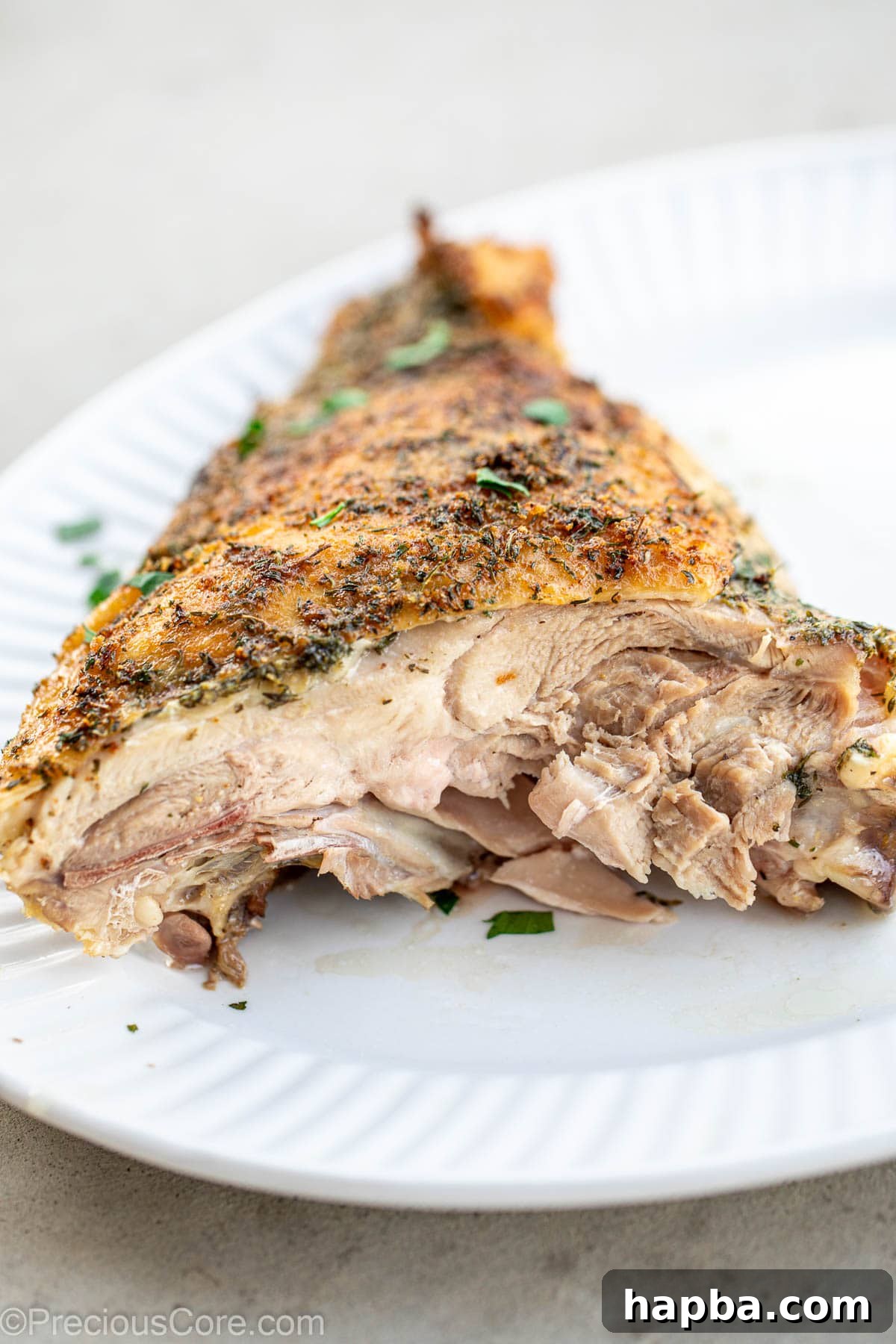 A perfectly cooked turkey thigh, cut to show the juicy interior.