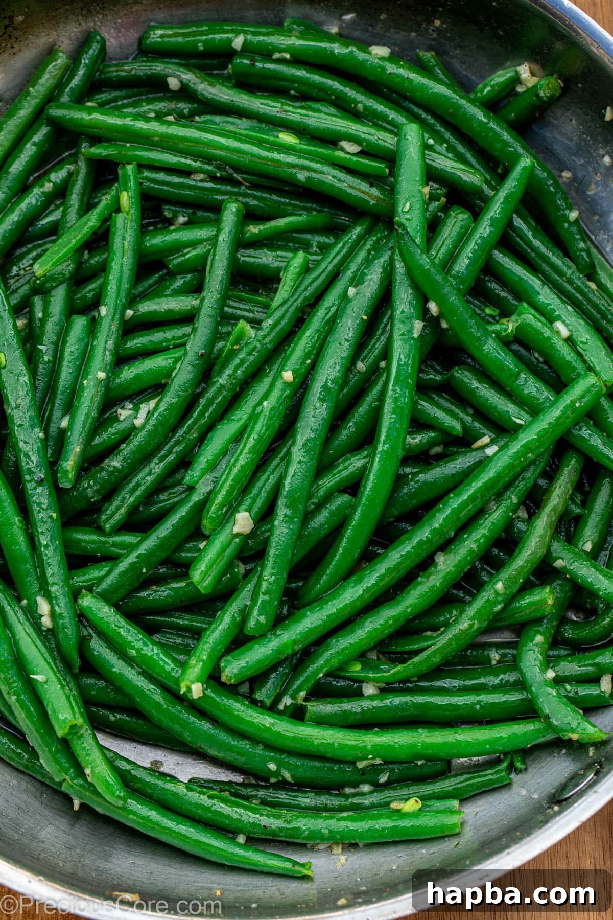 Skillet of perfectly cooked garlic butter green beans, ready to serve.