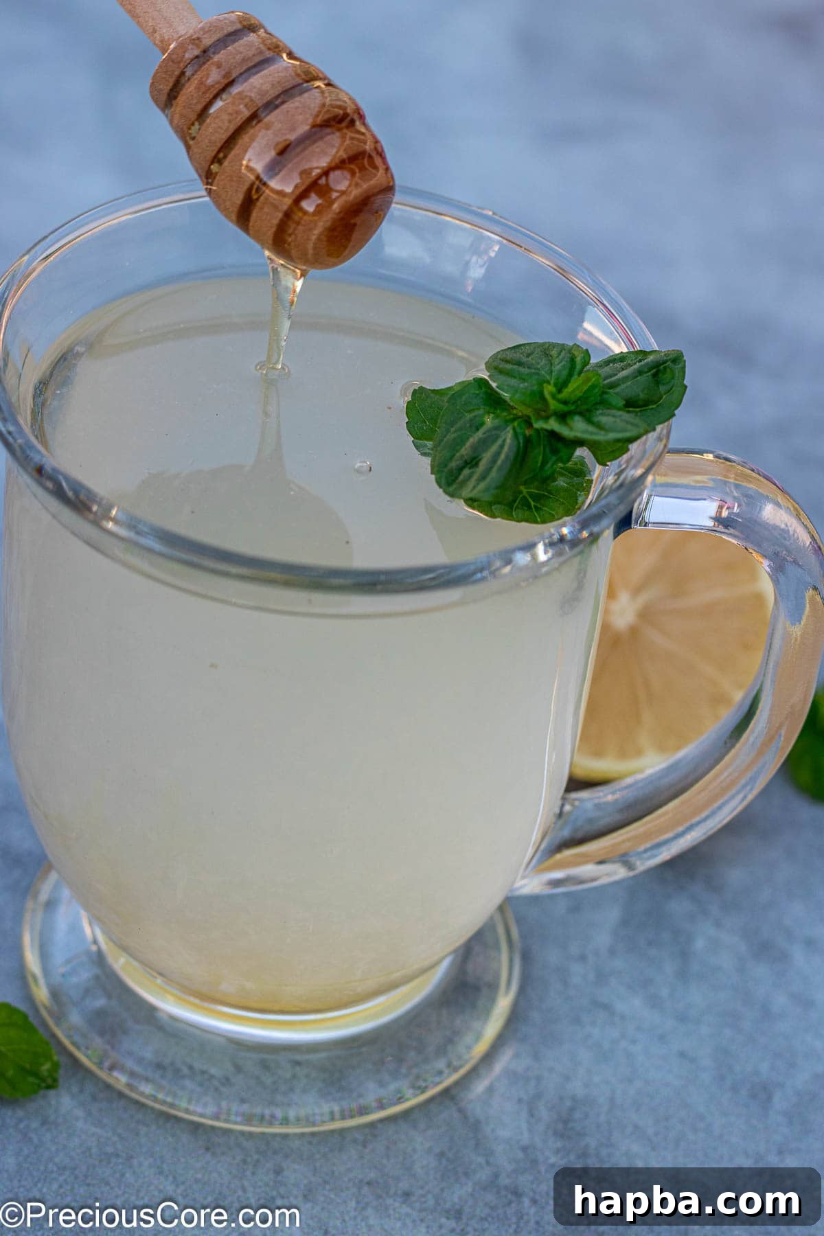 A warm mug of golden honey lemon tea, a perfect comforting beverage on a cold day.