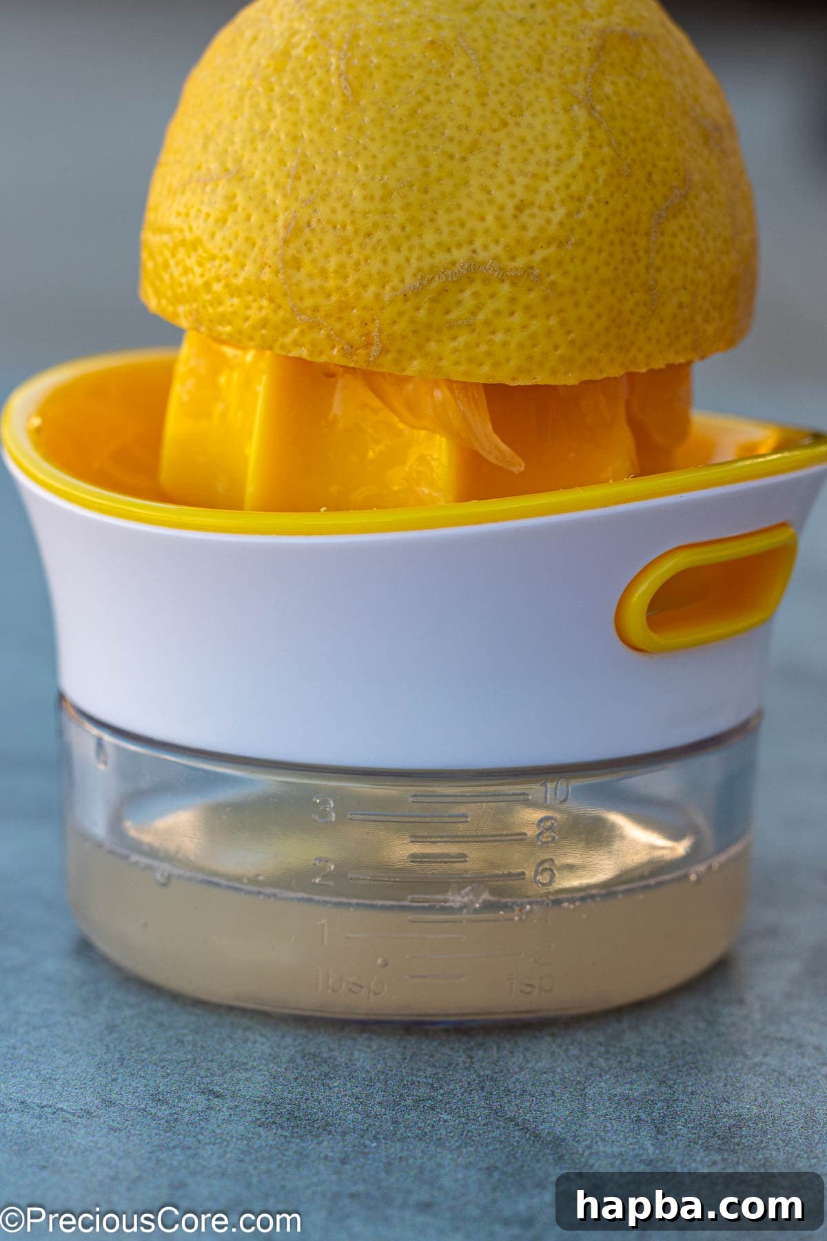 Fresh lemon juice being squeezed using a practical lemon squeezer for convenience and efficiency.