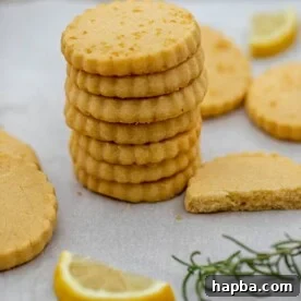 A perfectly stacked pile of delicate lemon shortbread cookies, showcasing their golden edges and inviting texture.