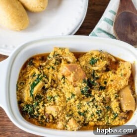 Traditional Nigerian Egusi Soup, a vibrant and hearty stew, often served with fufu.