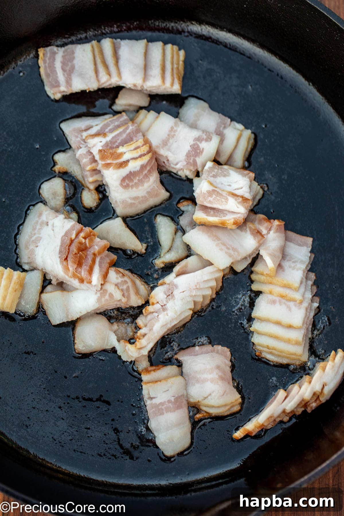 Caramelized Brussels Sprouts with Crispy Bacon 6 Sliced bacon in a cast iron skillet.
