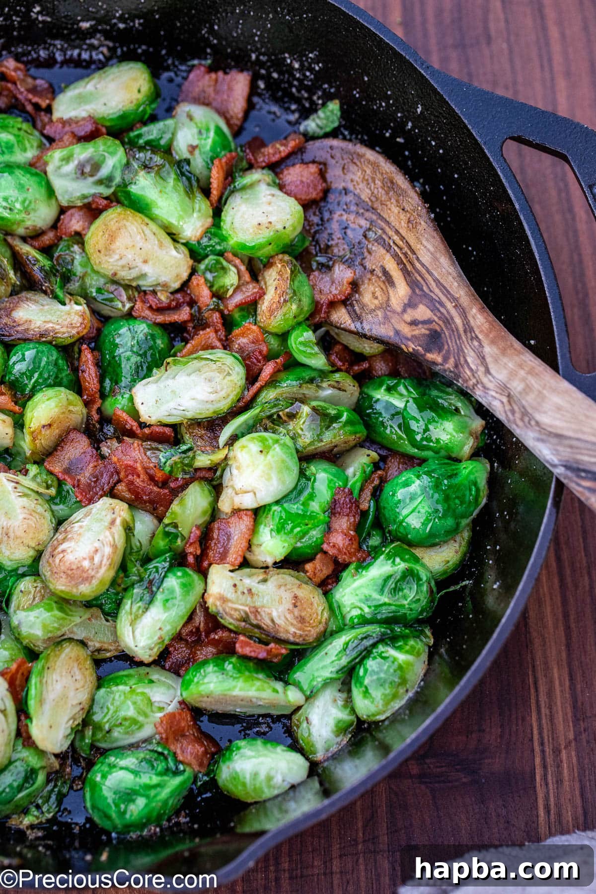 Caramelized Brussels Sprouts with Crispy Bacon 10 Cooked bacon with Brussels sprouts in a skillet.