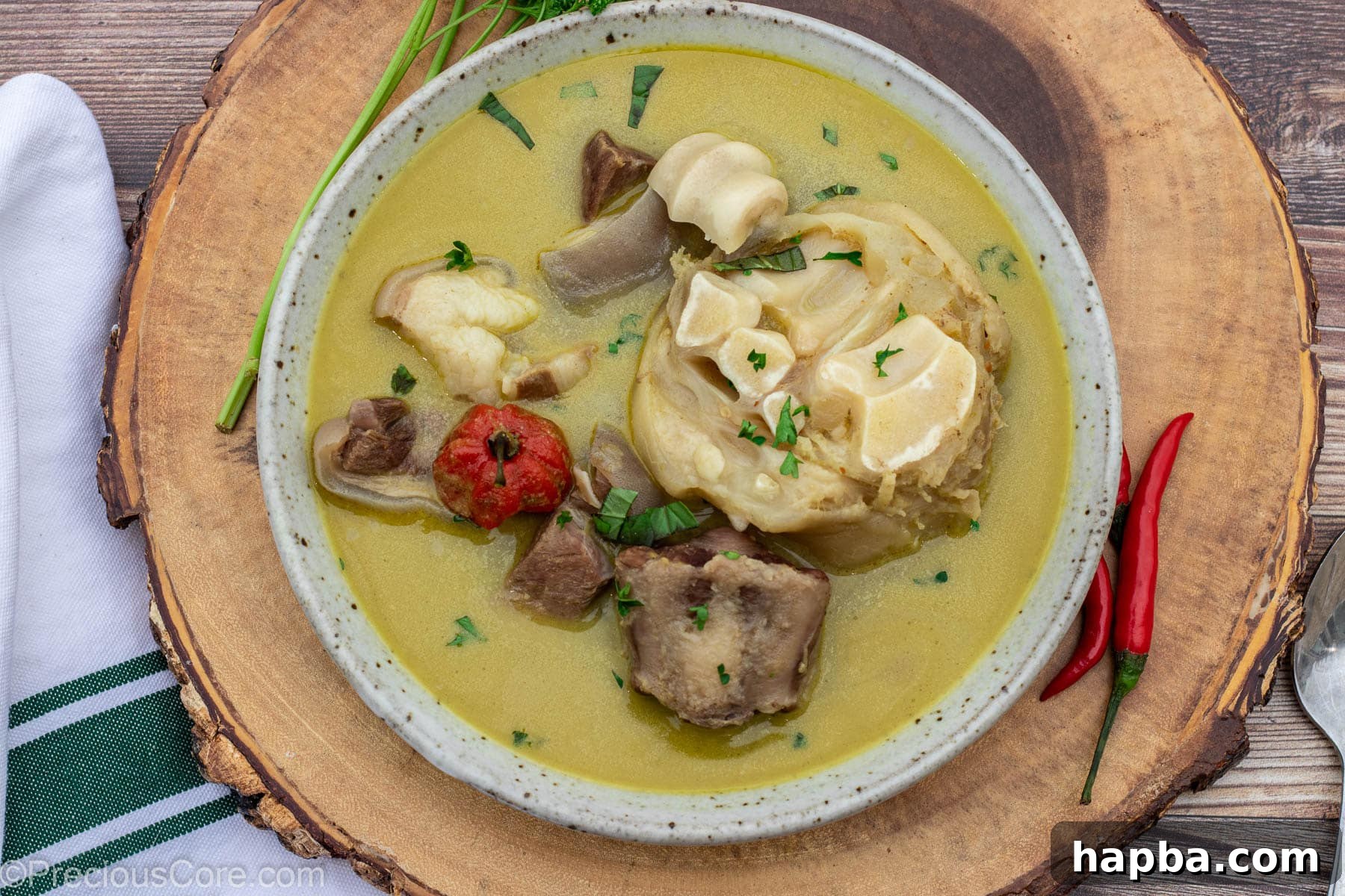 A landscape shot showcasing the vibrant Cameroonian Pepper Soup, invitingly prepared for serving.