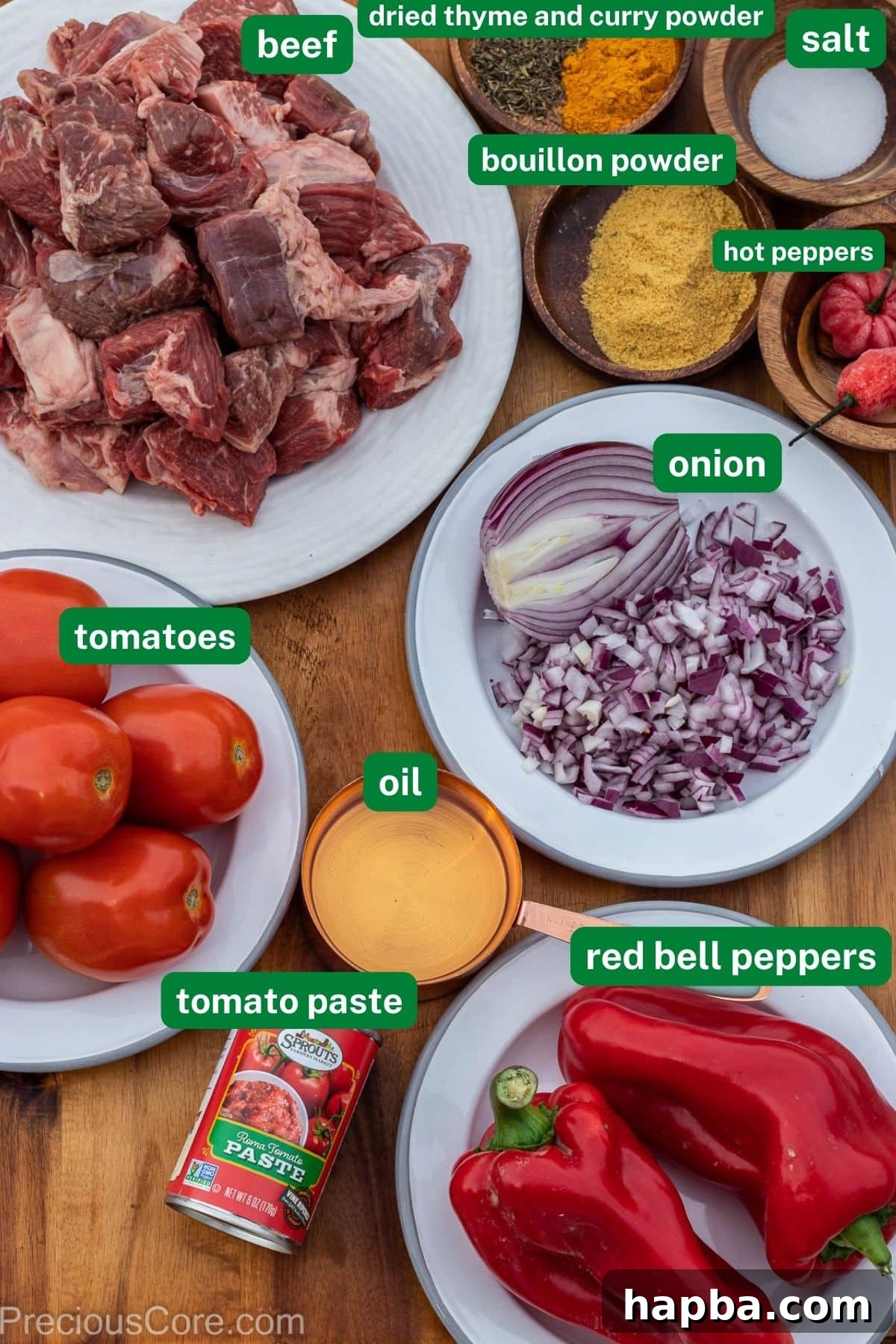 All the fresh ingredients laid out for making Nigerian Beef Stew, including beef, tomatoes, bell peppers, onions, and spices.