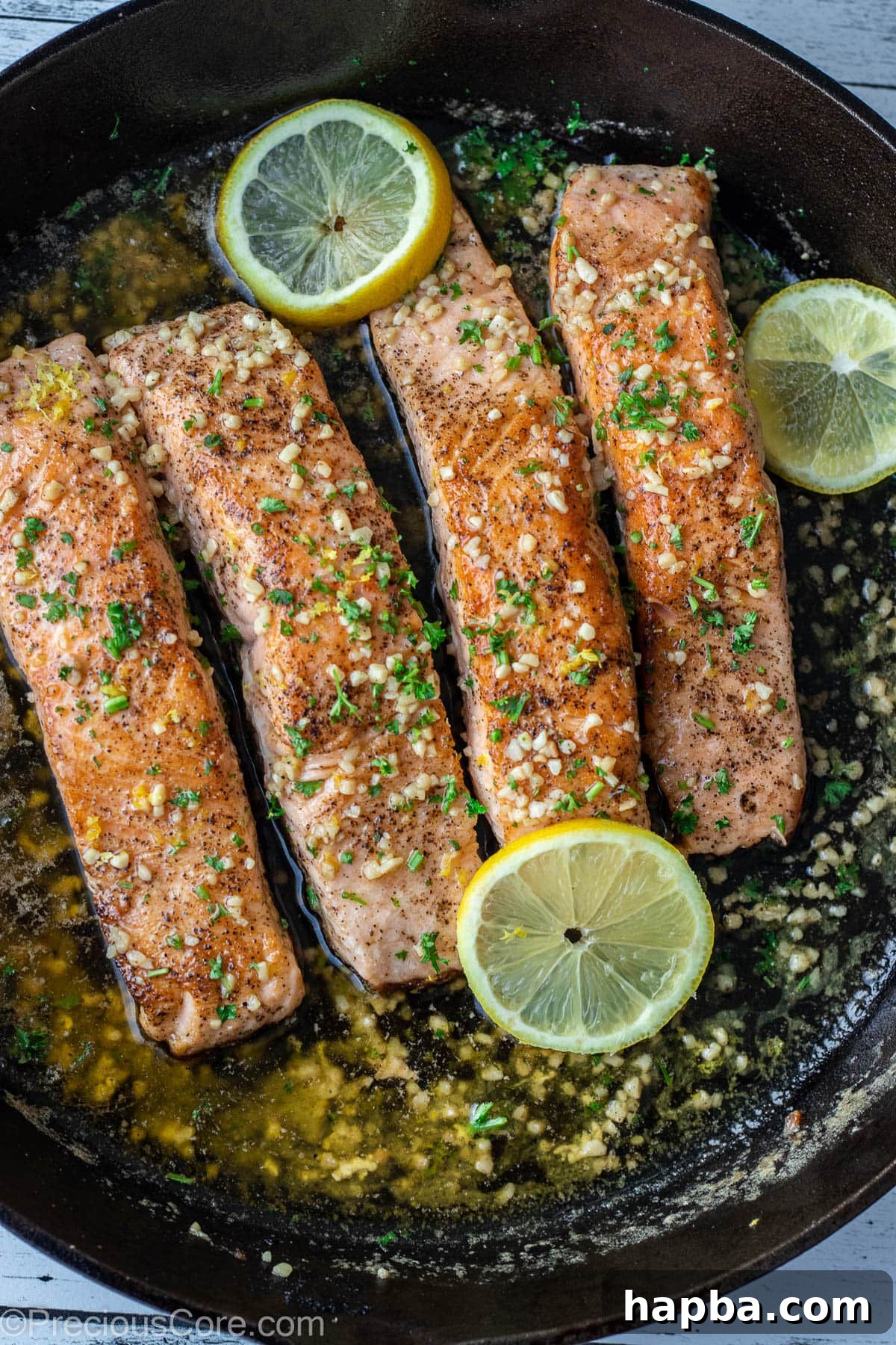 Zesty Lemon Butter Salmon 2 4 pieces of salmon in a cast iron skillet.