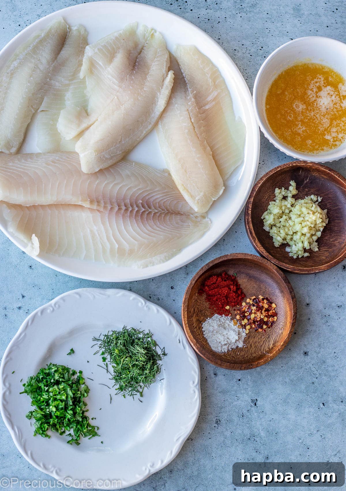 Ingredients for Garlic Butter Tilapia laid out on a kitchen slab.