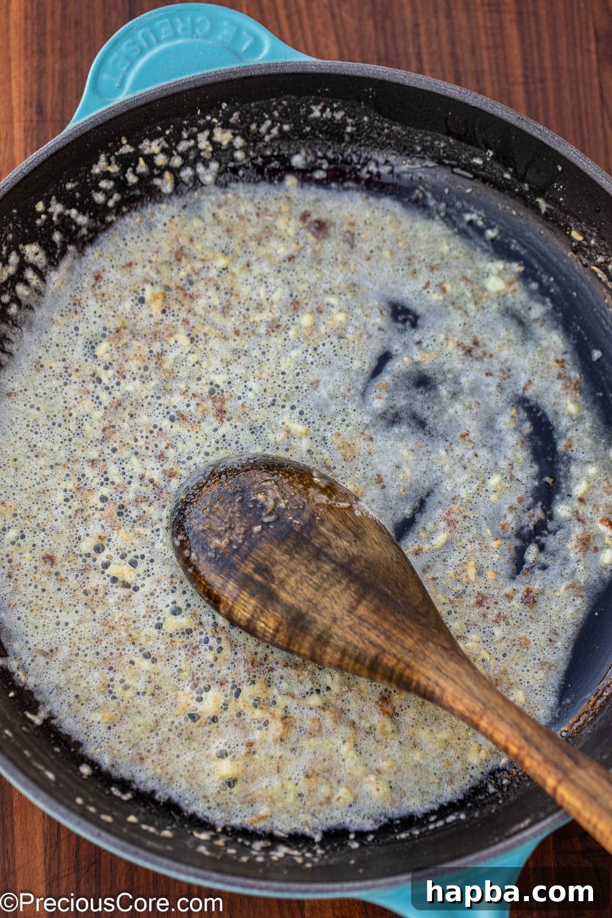 Creamy White Sauce Fish 7 Minced garlic, melted butter, and flour combining in a skillet to form the roux.