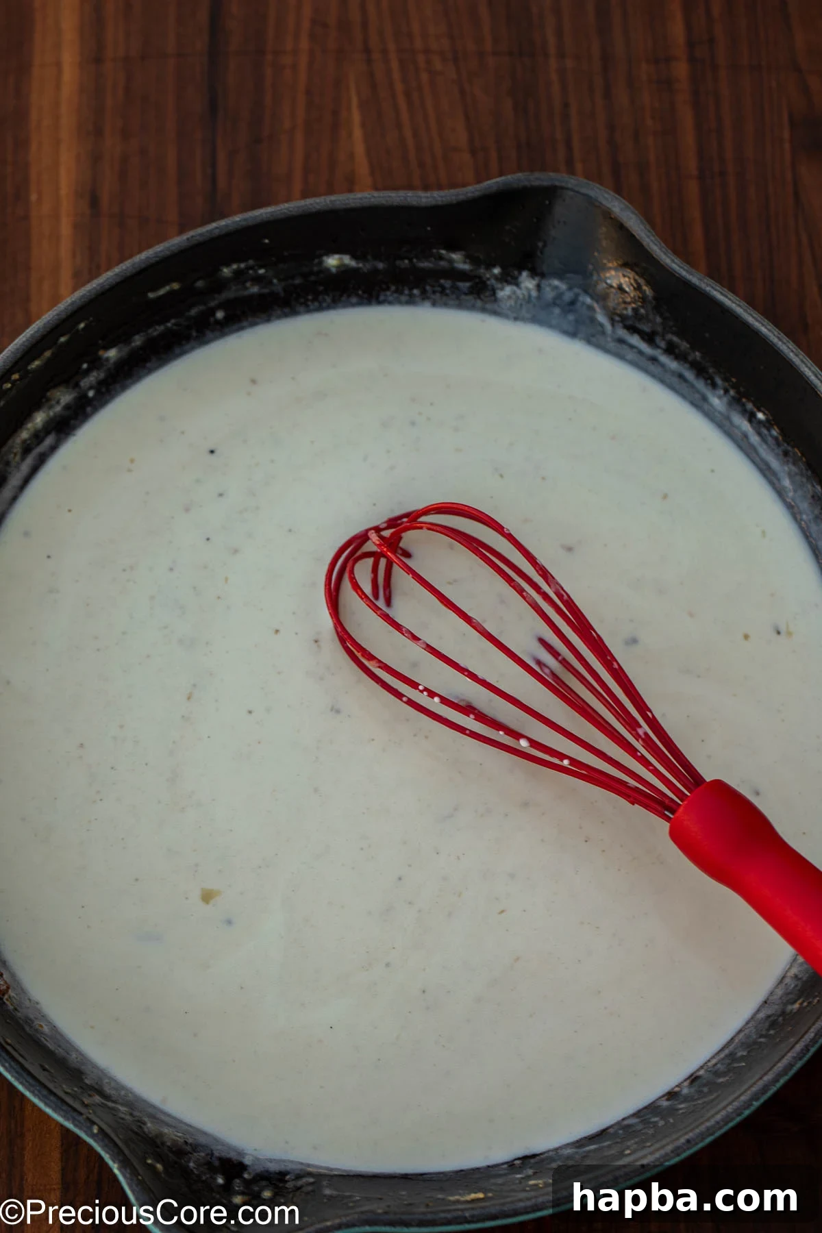 Creamy White Sauce Fish 9 The creamy white sauce gently simmering in a pan, thickening beautifully.