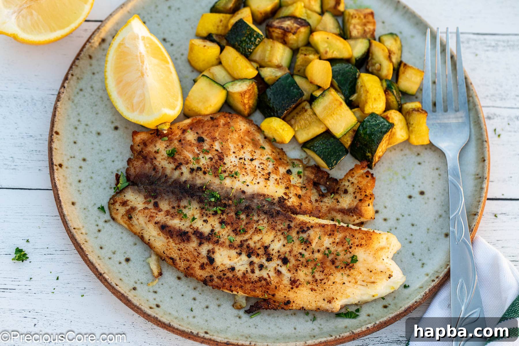 Zesty Lemon Pepper Tilapia 7 Landscape image of lemon pepper tilapia with vegetables.