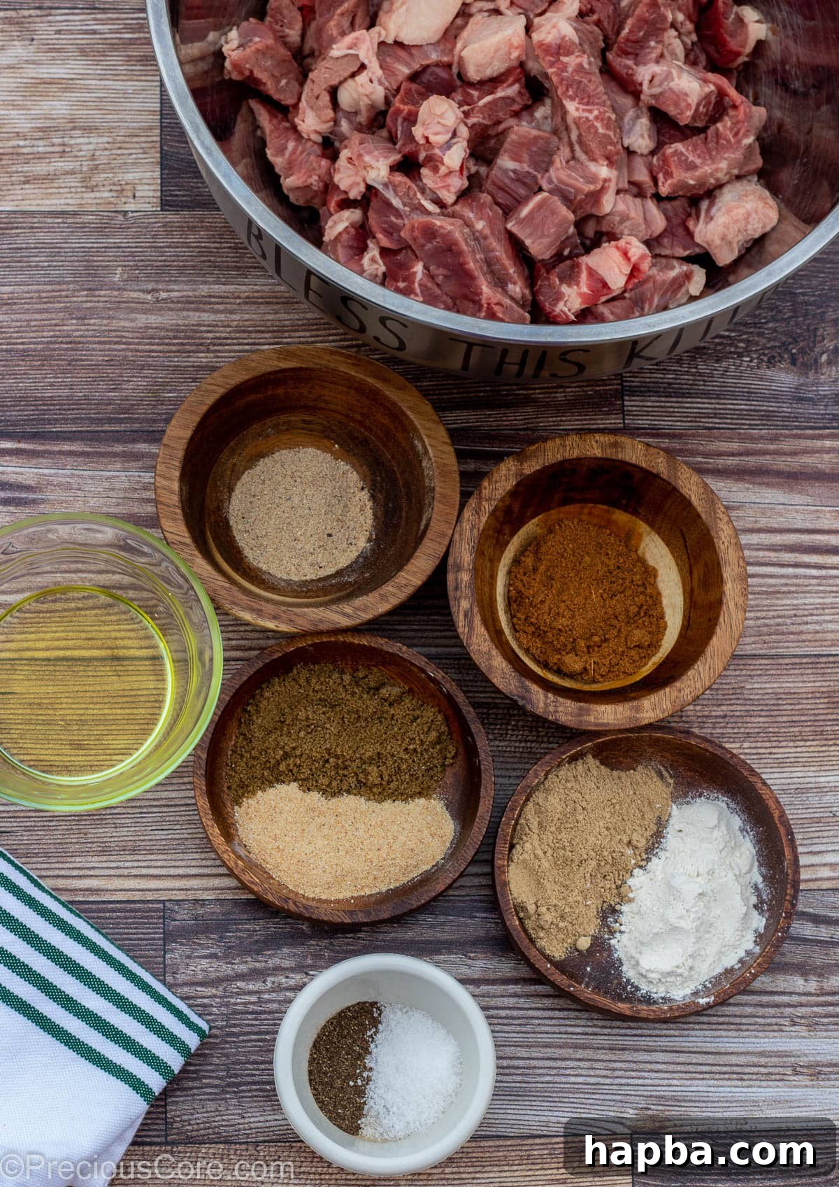 Cameroonian Soya Morsels 4 Ingredients for Cameroonian Soya laid out on a brown board, highlighting fresh spices and quality beef.