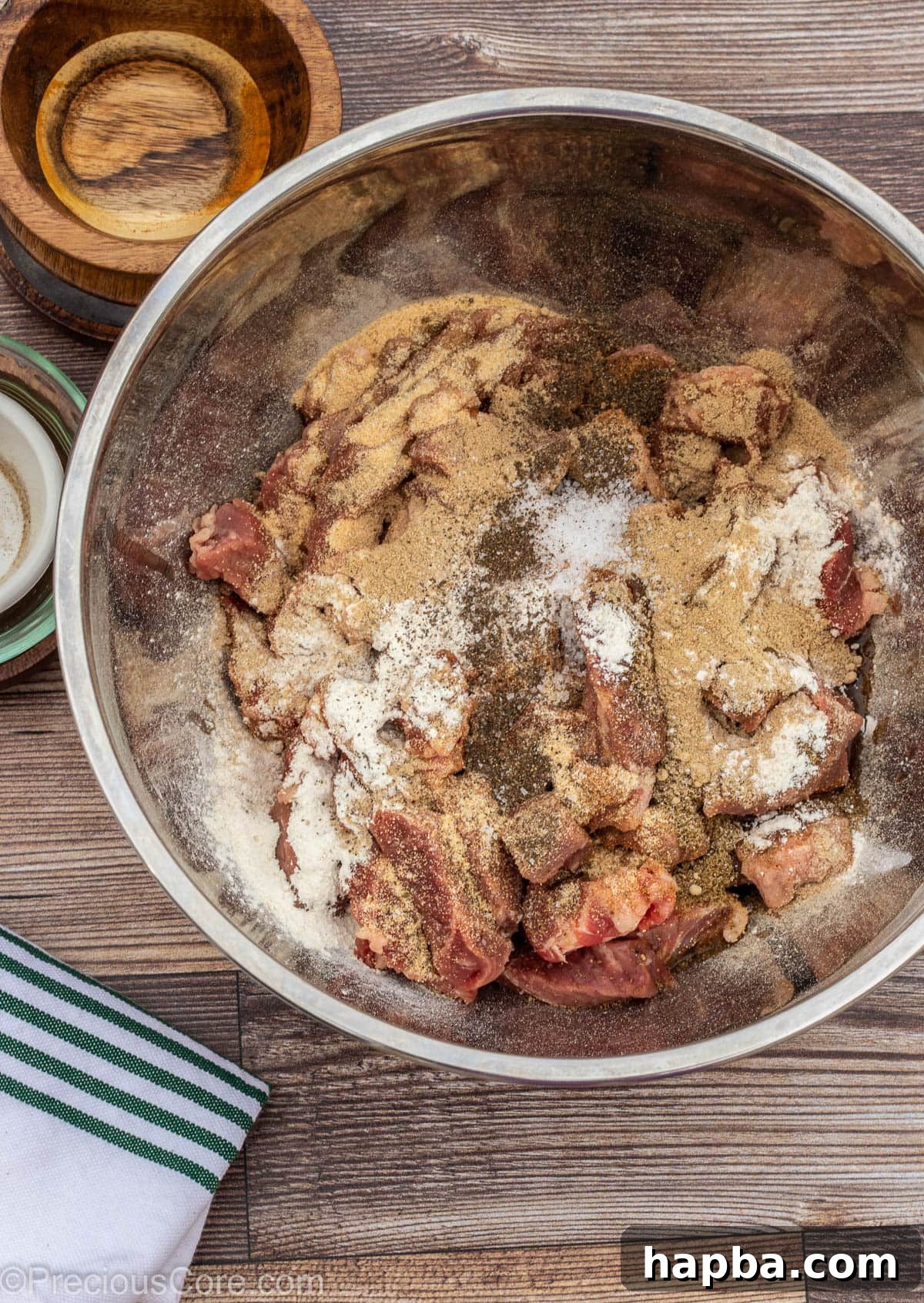 Cameroonian Soya Morsels 5 Beef in a bowl with oil and spices on top, ready to be mixed for Cameroonian Soya.