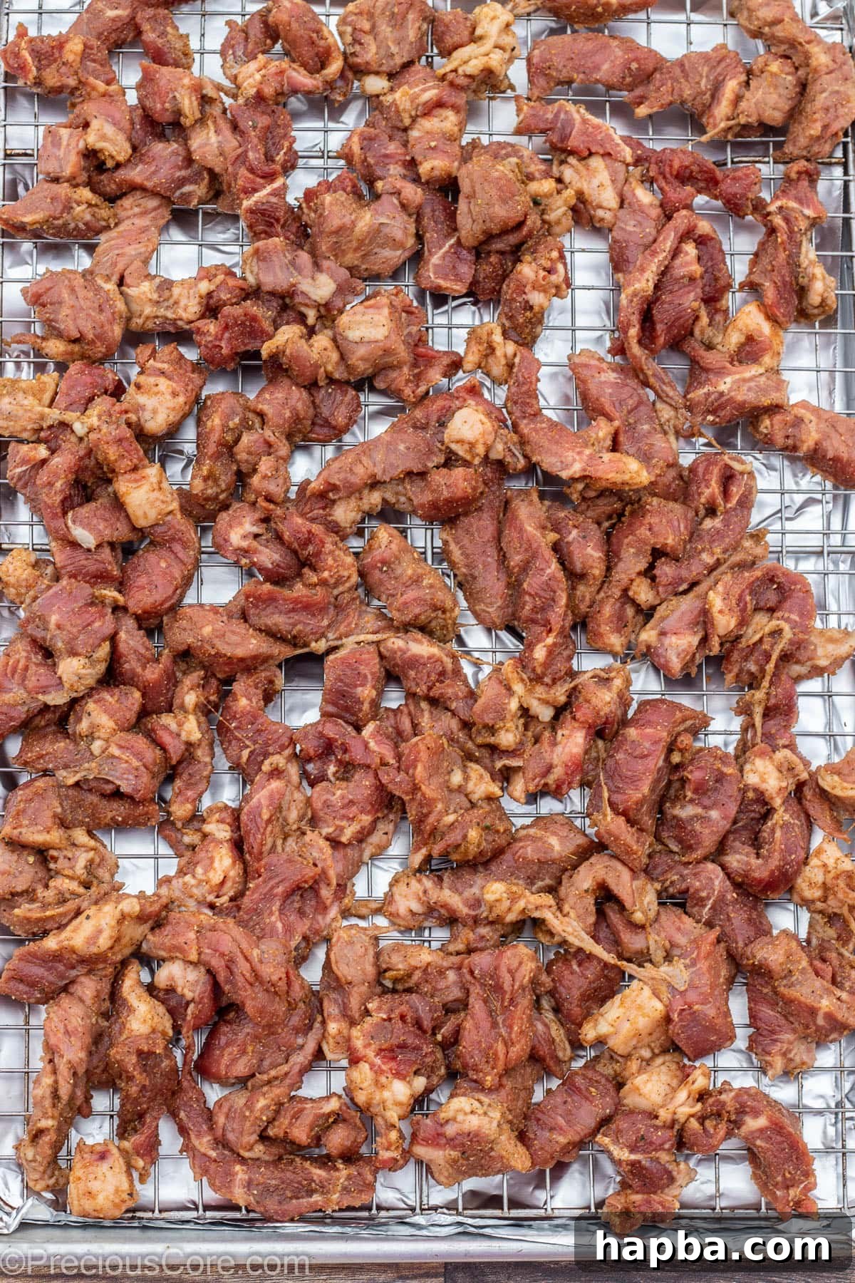 Cameroonian Soya Morsels 7 Beef on a baking sheet rack, arranged in a single layer for optimal broiling.
