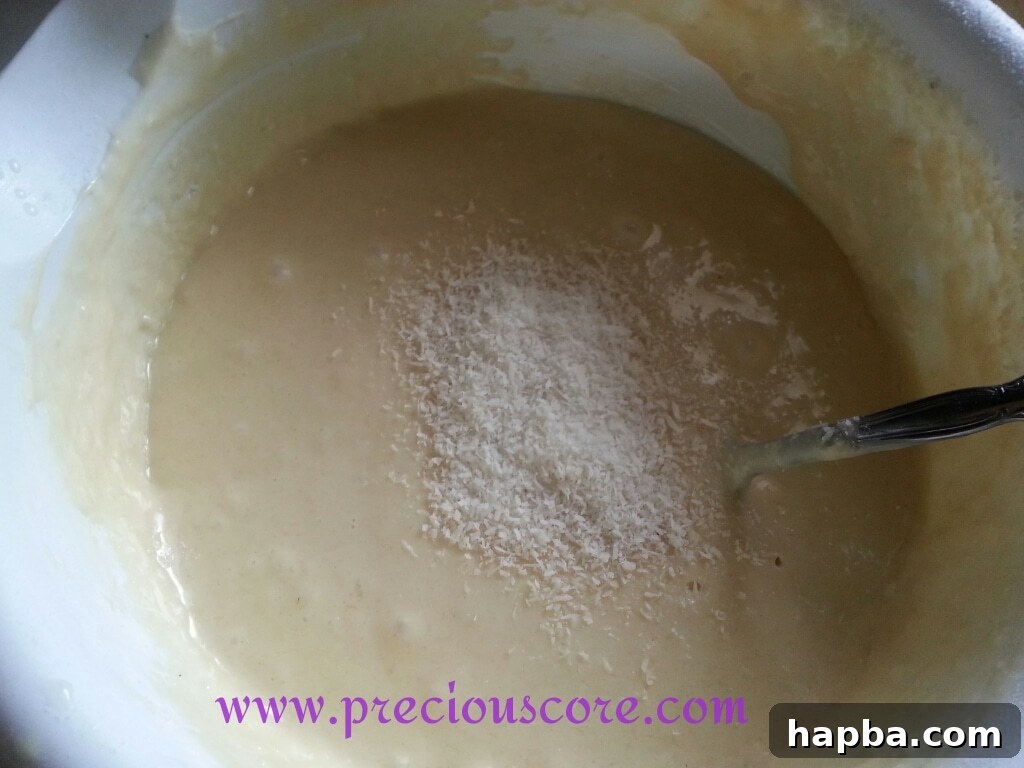 Shredded coconut being folded into pancake batter
