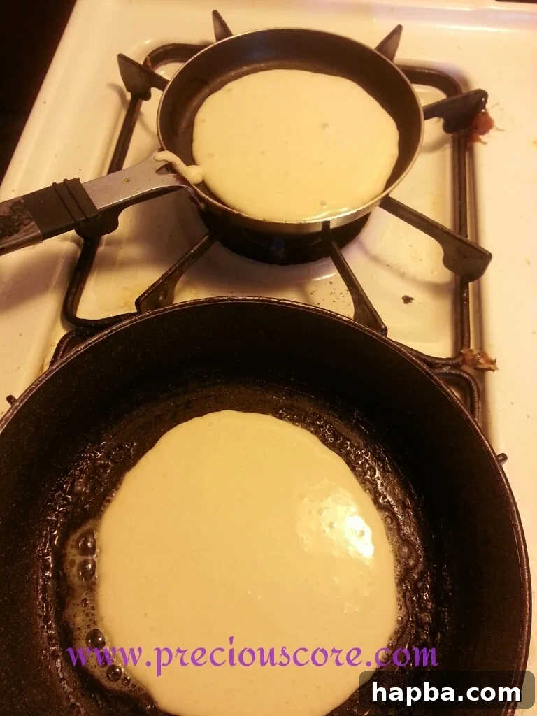 Pancake batter cooking on a skillet