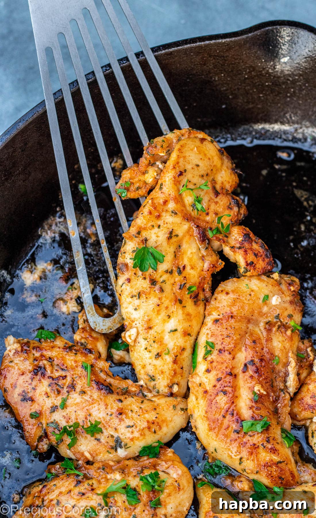 Crispy Pan-Seared Chicken Tenders 2 Spatula holding a perfectly cooked, golden-brown chicken tenderloin.