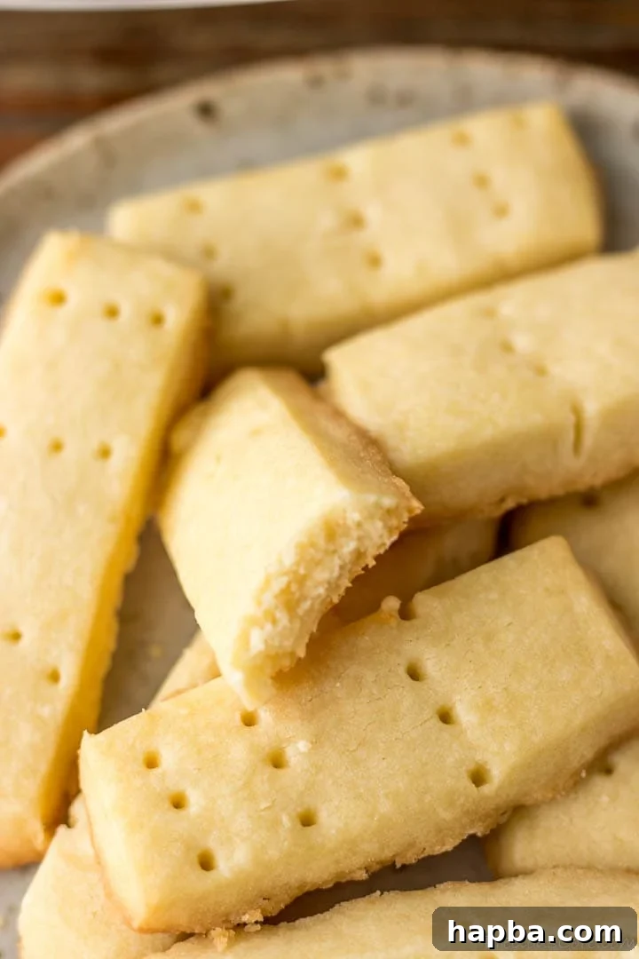 Shortbread cookies with one bitten to reveal crumbly texture