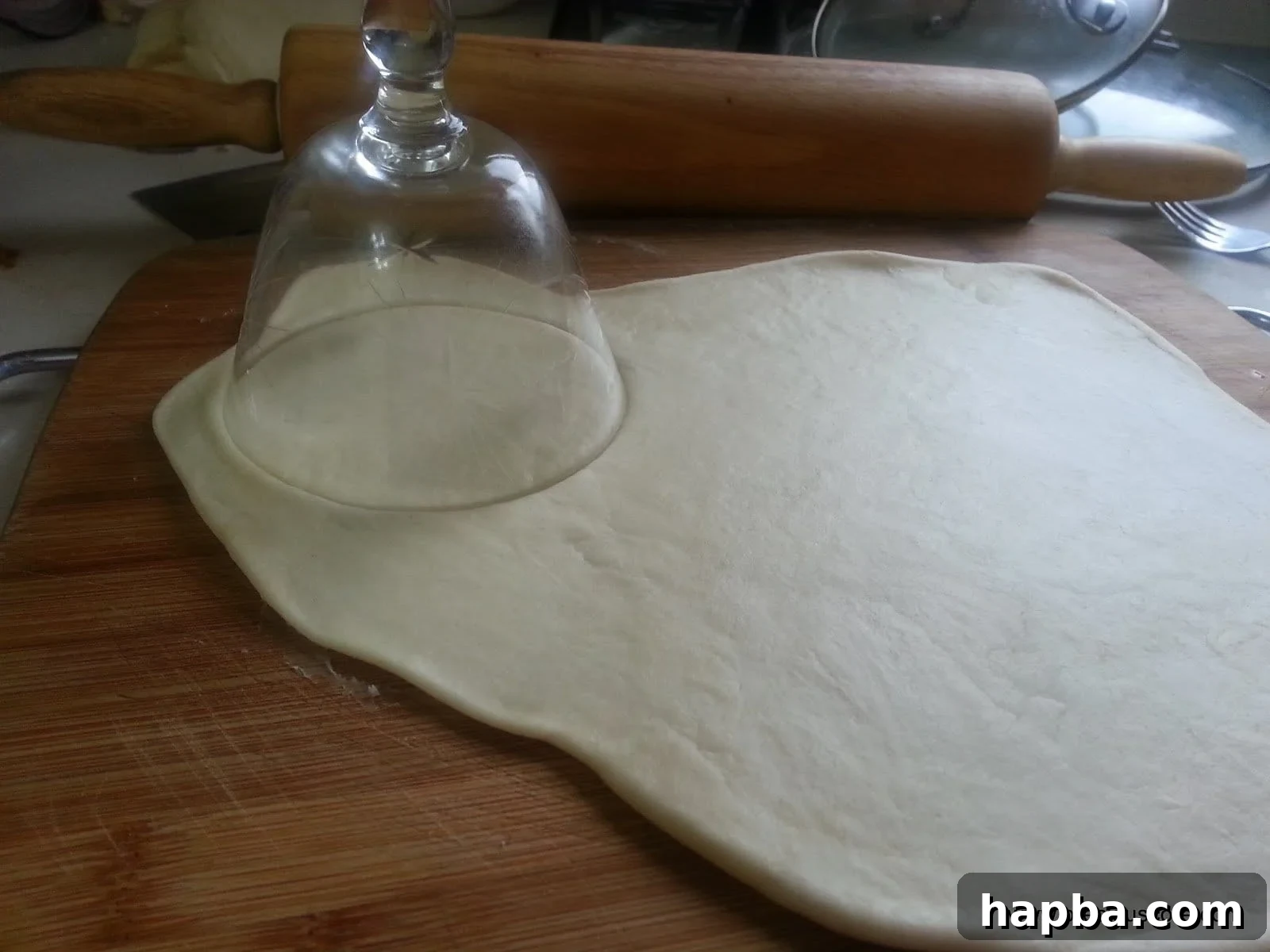 Dough being rolled out and cut into circles