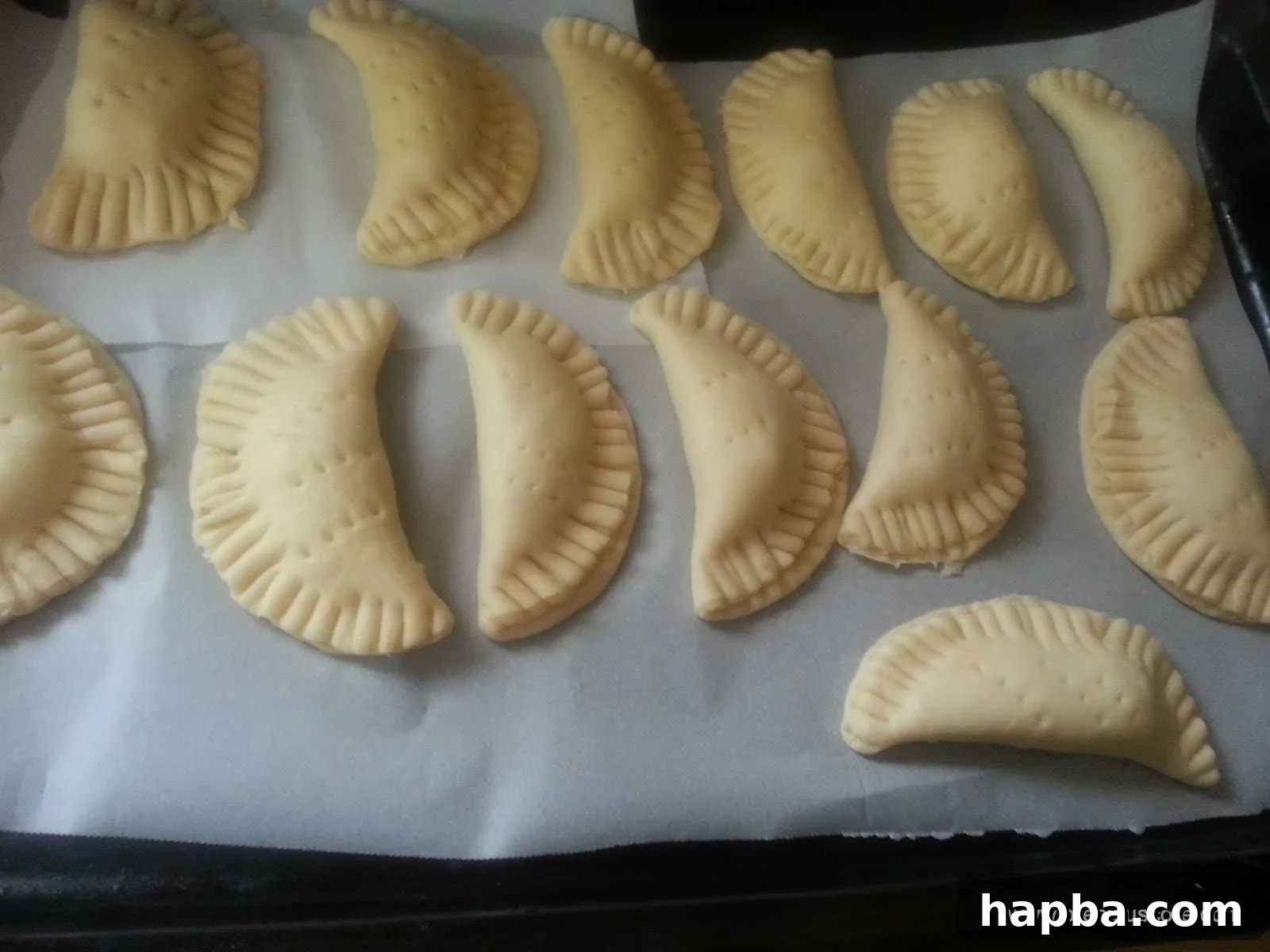 Assembled fish pies on a baking tray