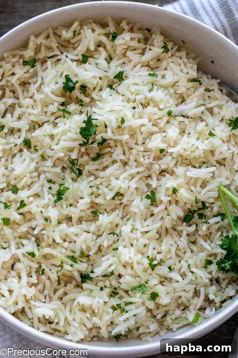 A simple yet elegant presentation of fluffy cooked rice in a pristine white bowl, showcasing its delicate texture.