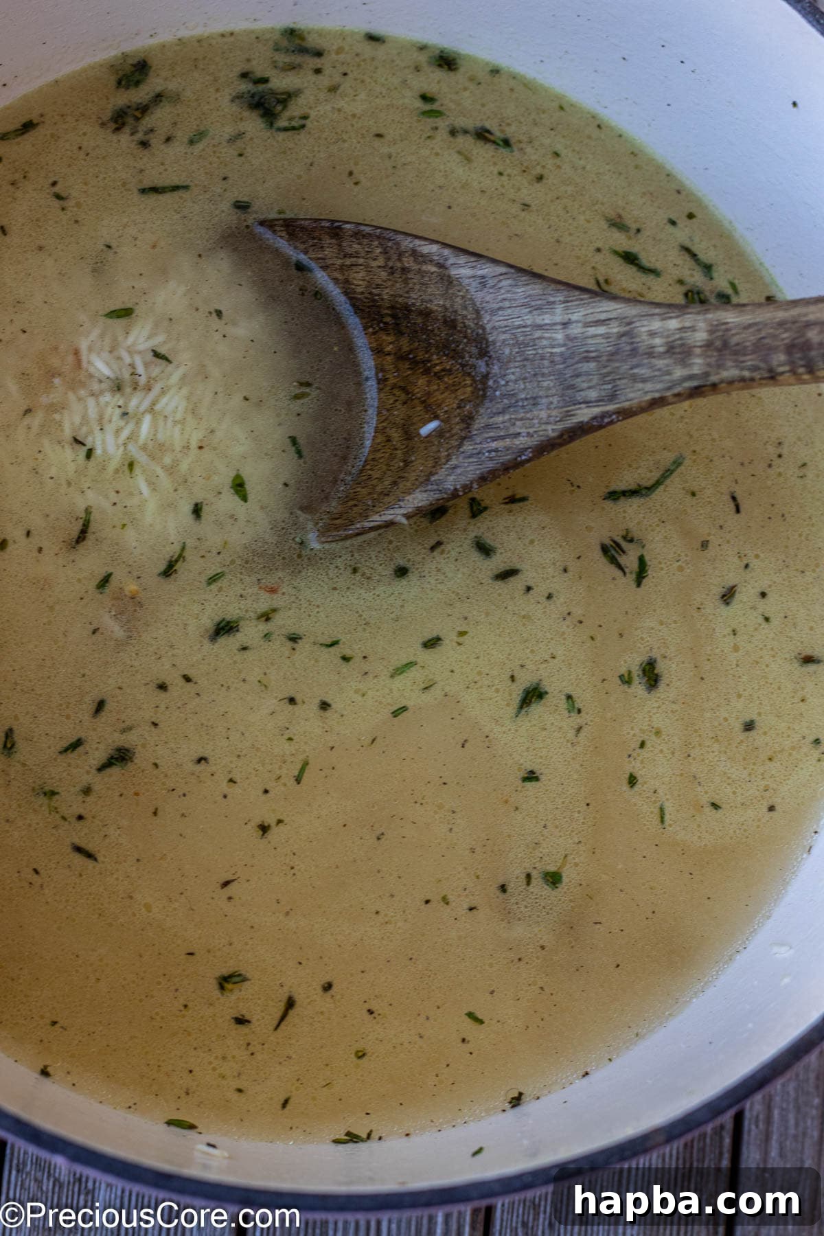 Water and essential seasonings added to the toasted rice, preparing for the final cooking stage.