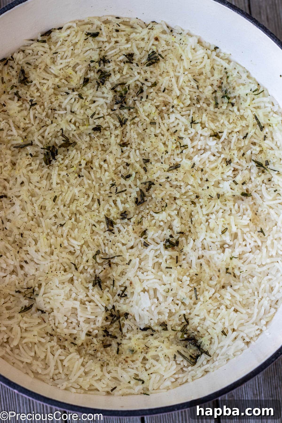 Fluffy, aromatic garlic herb rice perfectly cooked and resting within a lidded pot, ready for the final touches.