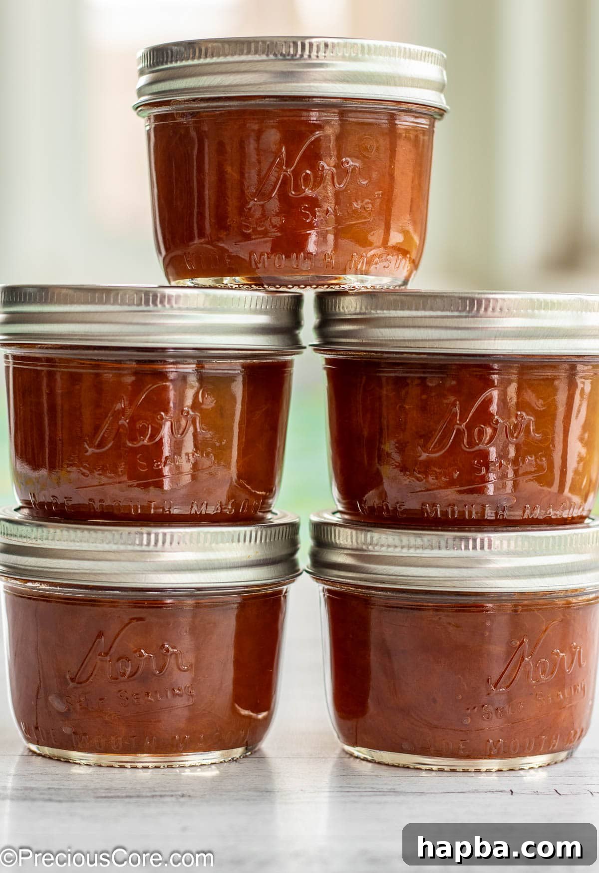 Sunshine Apricot Spread 12 Five jars of homemade apricot preserves, neatly stacked, showcasing their beautiful golden color.