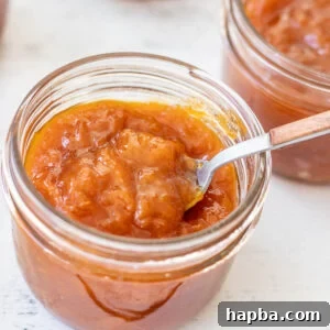 A beautiful jar of homemade apricot preserves, showcasing its rich color.