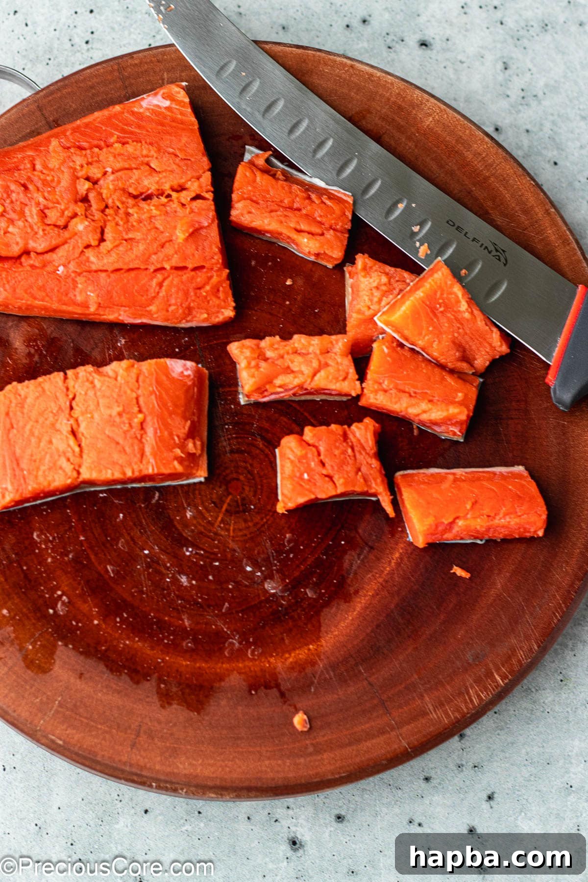 Crispy Salmon Bites 5 Salmon fillet cut into 1-inch cubes on a chopping board.