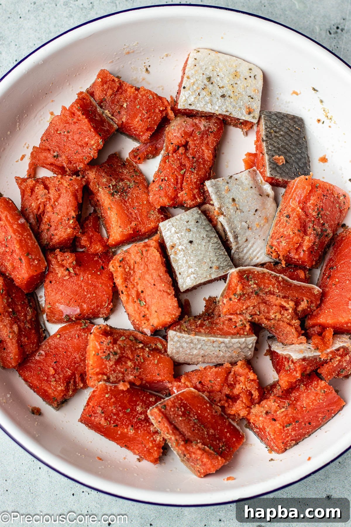 Crispy Salmon Bites 6 Seasoned salmon cubes in a bowl, ready for cooking.