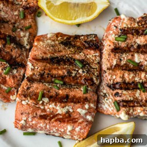 Grilled Sockeye Salmon steaks on a white plate, ready to serve.