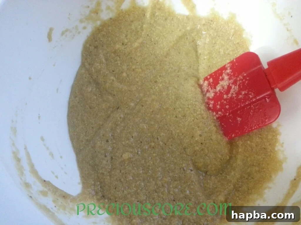 Banana and garri mixture after stirring, showing a thick, cohesive batter.