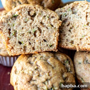 Zucchini muffin cut in half to show texture.