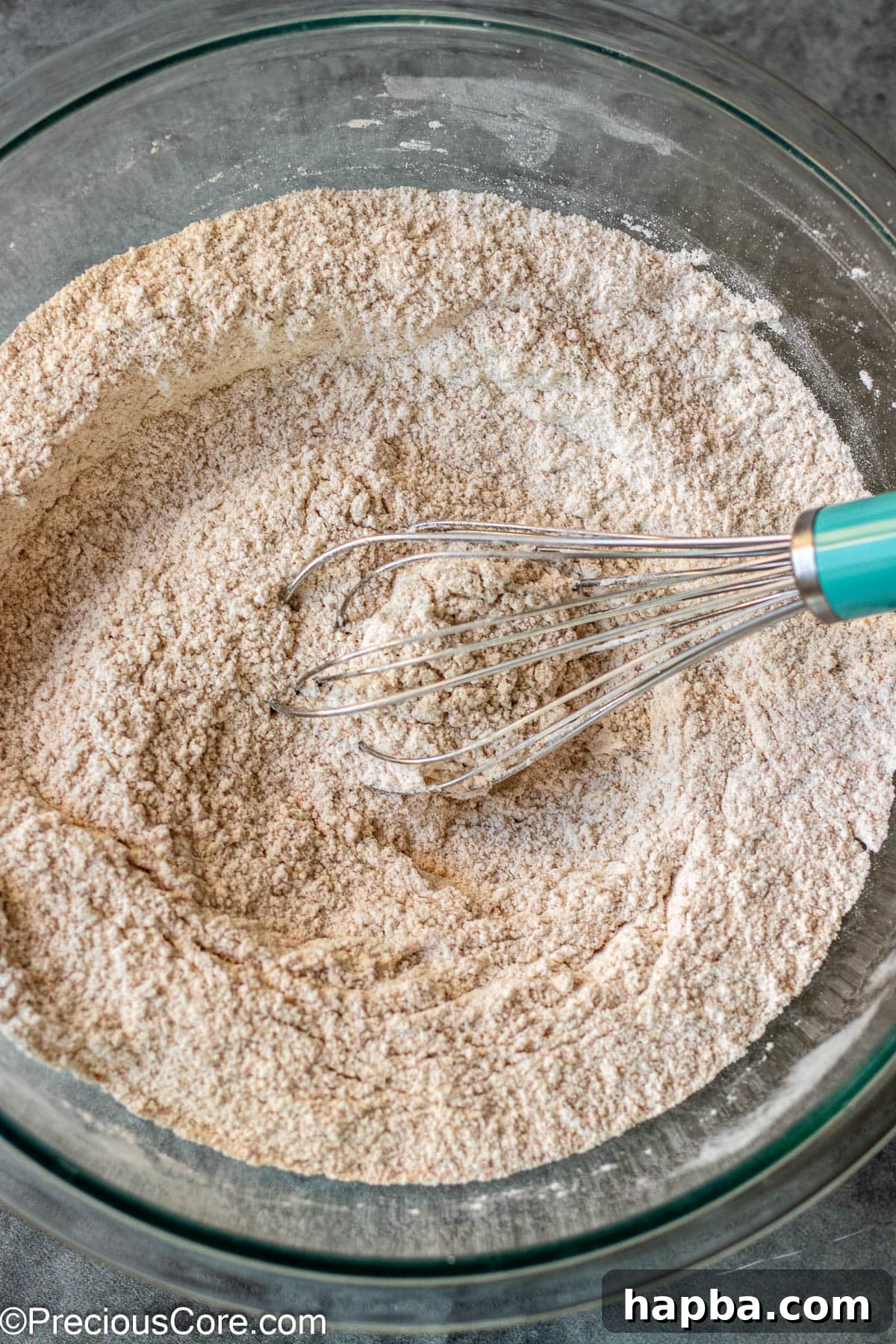 Wholesome Zucchini Applesauce Muffins 6 Dry ingredients for muffins, now fully whisked together in a bowl, appearing uniform.