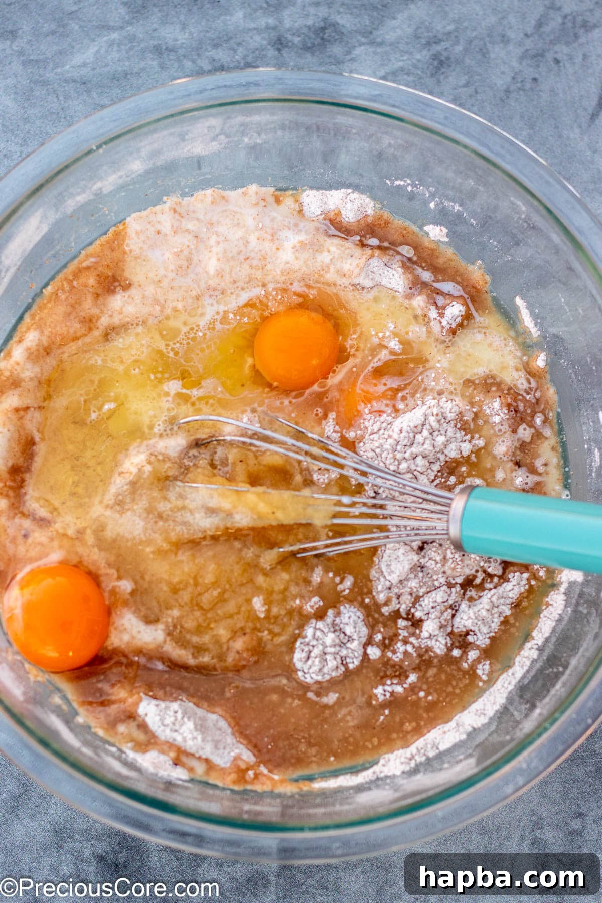 Wholesome Zucchini Applesauce Muffins 7 Various wet ingredients for muffins, including eggs, milk, applesauce, and oil, prepared in a separate bowl.