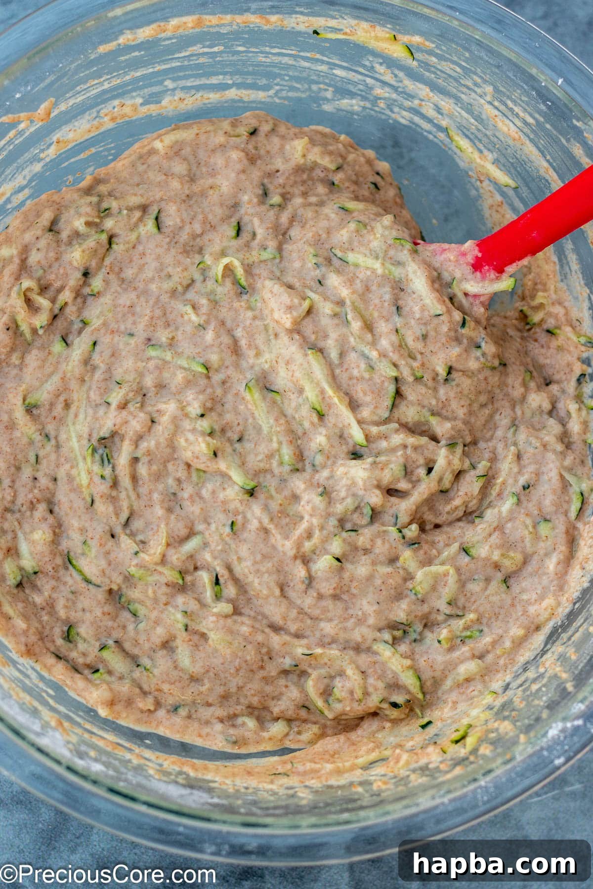 Wholesome Zucchini Applesauce Muffins 10 The complete zucchini muffin batter, with shredded zucchini incorporated, resting in a bowl, ready for baking.